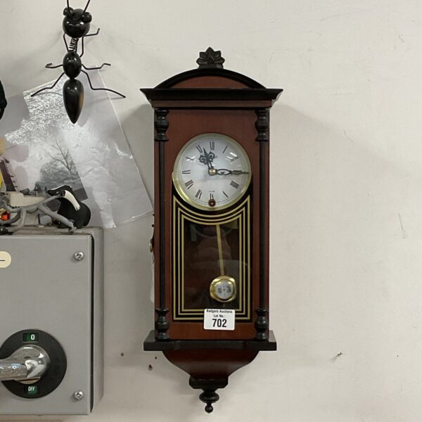 Vintage Highland wall clock with a wooden case and Roman numerals.