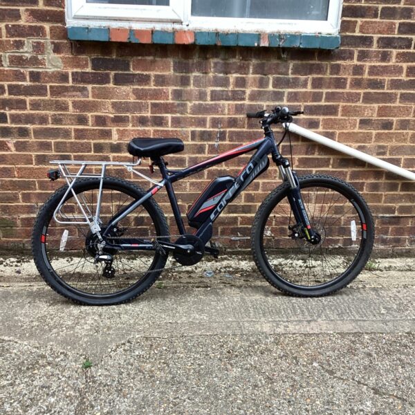 Front view of a black Carrera electric bike with suspension.