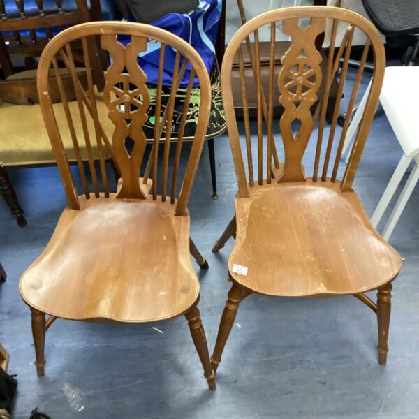Pair of vintage Ercol wheelback chairs with steam-bent beechwood frames.