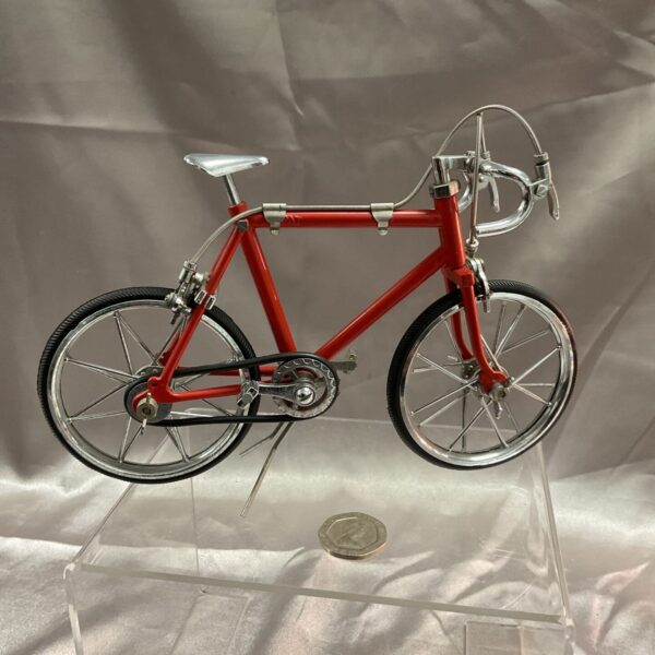 Detailed red metal racing bicycle model for collectors.