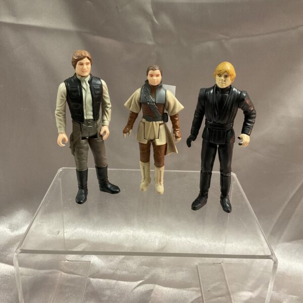 Vintage 1984 Star Wars figures of Han Solo, Leia, and Luke Skywalker.