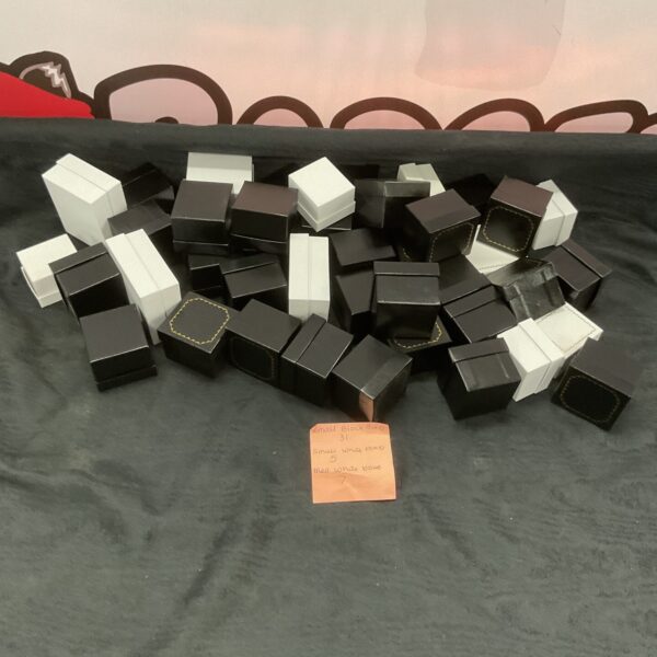 Assortment of empty jewellery boxes in black and white.