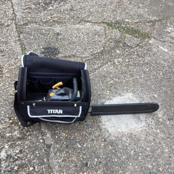 Titan petrol chainsaw in a black carrying case, garden tool.