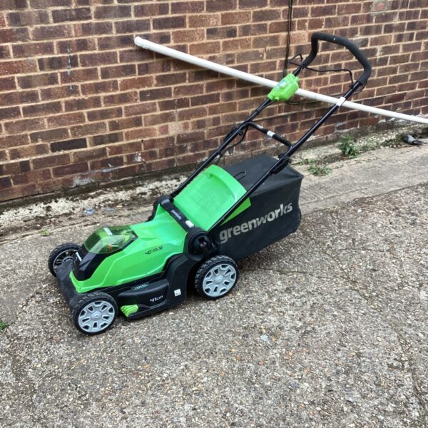 Greenworks 40V battery powered lawnmower in a garden setting.