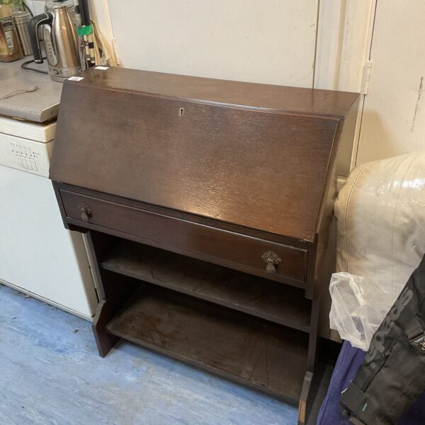Vintage mahogany writing desk with drawers and shelving.