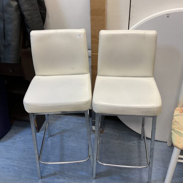 Pair of white leatherette bar stools with chrome legs.