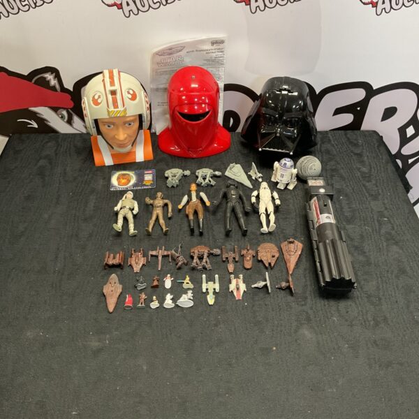 Overview of a vintage Star Wars micromachines lot with playsets and figures.
