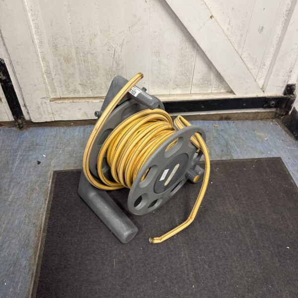 Grey Hozelock garden hose reel with yellow hose wound around it.
