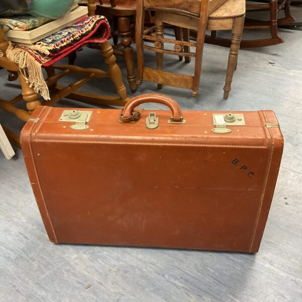 Large vintage brown leather travel case with handle.