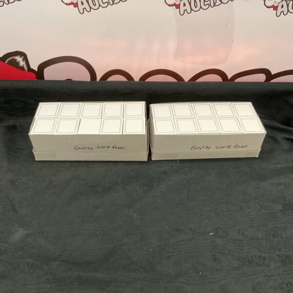 Two boxes of empty white jewellery boxes for presentation.