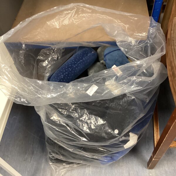 Blue neck cushions in a plastic bag, travel comfort items.
