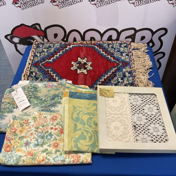Vintage wall rug with lace tablecloth and upholstery fabrics lot.
