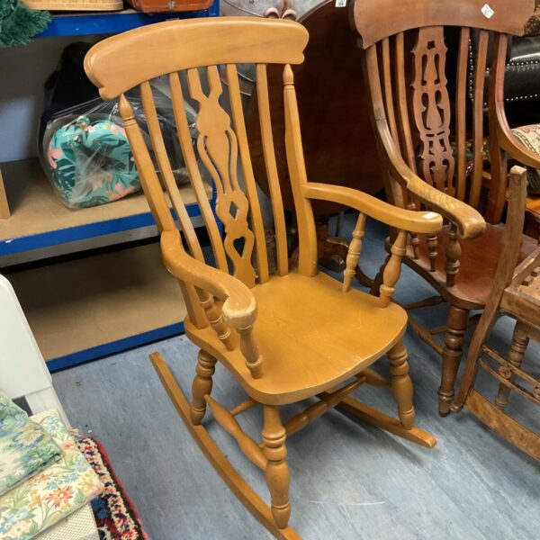 Antique wooden rocking chair with farmhouse style.
