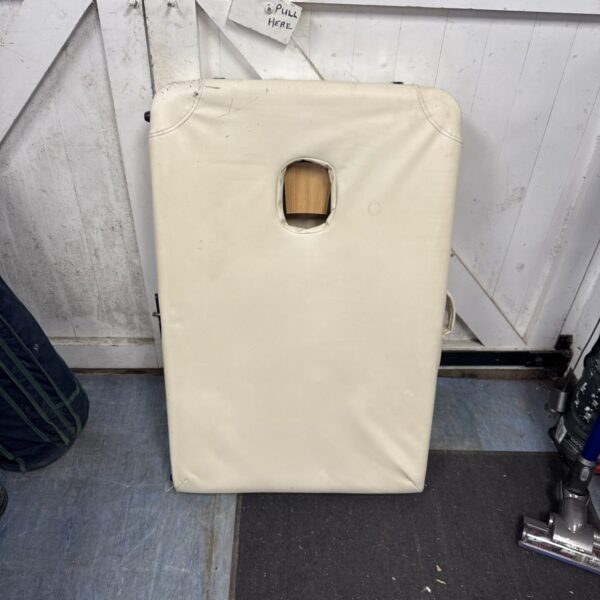 Padded folding massage table showing wear and tear.