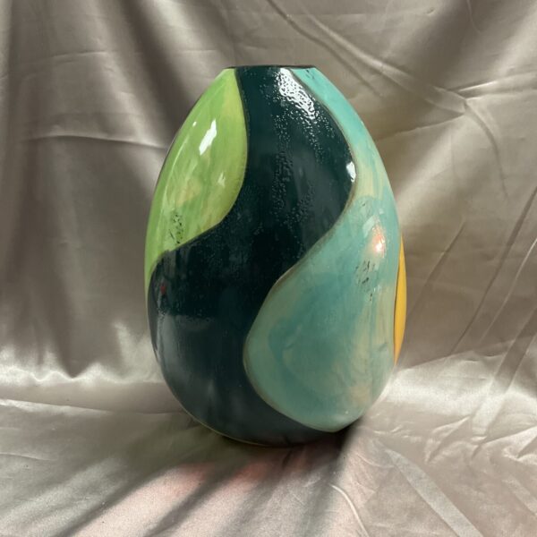 Teal and green studio pottery vase with amber accents.