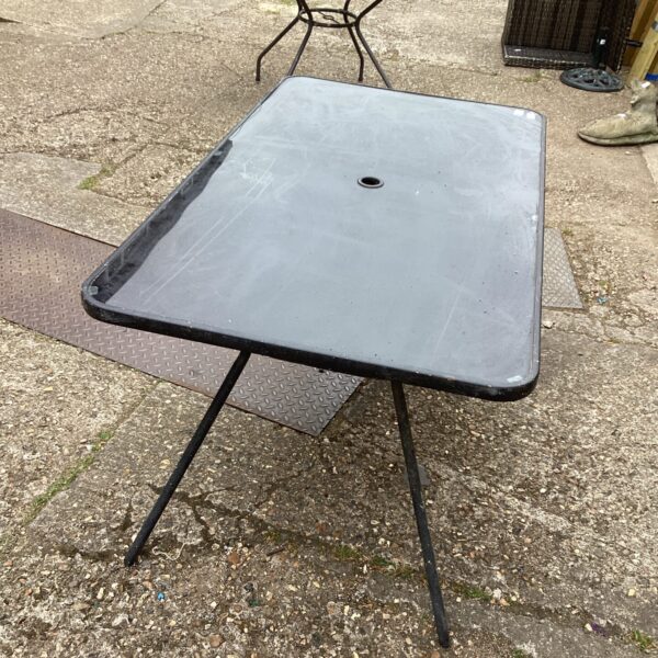 Large garden glass table with black metal frame.