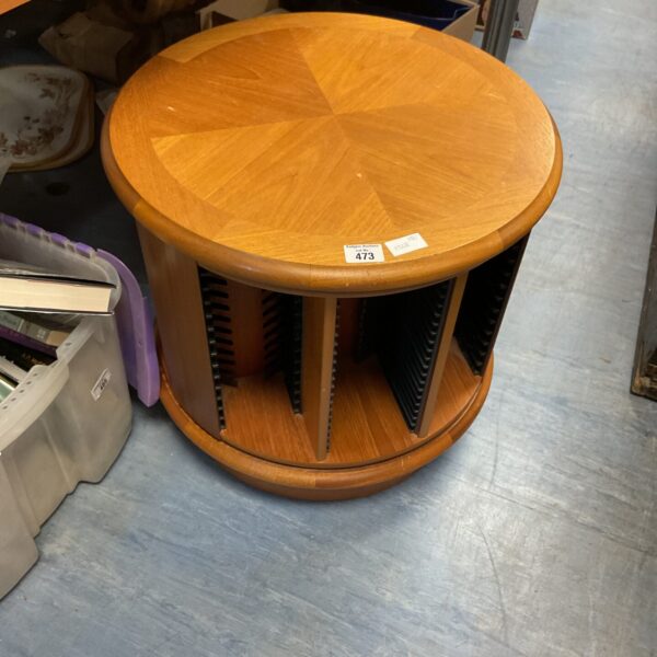 Circular pine CD rack for storing music albums.