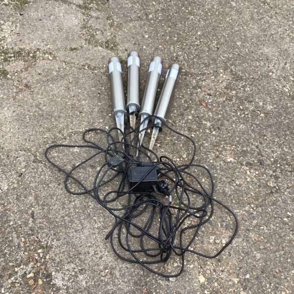 Set of four weathered garden lights with power supply.