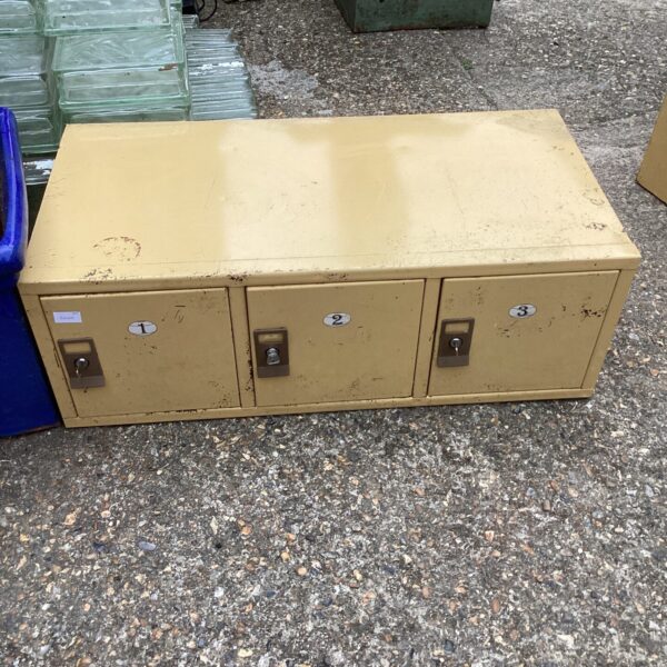 Set of vintage metal lockers with locking mechanisms.