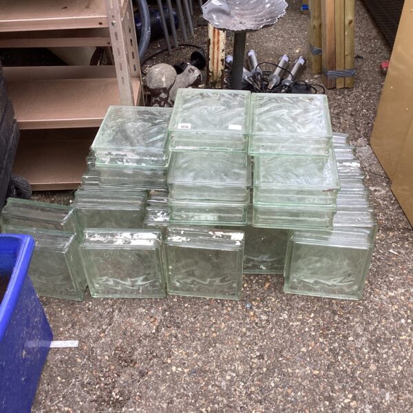 Close-up of textured glass bricks with a blue container.