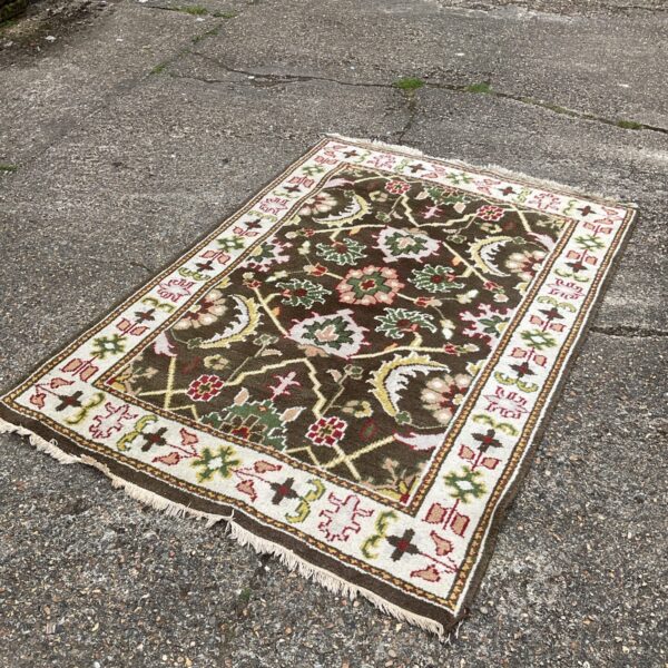 Detailed view of a vintage brown patterned rug.