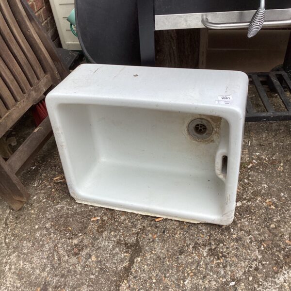 Vintage Belfast sink with a deep basin and ceramic construction.