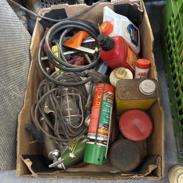 Mixed garage clearance lot with automotive fluids and tools.