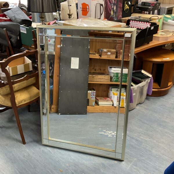 Large bevelled edge mirror for wall decoration.