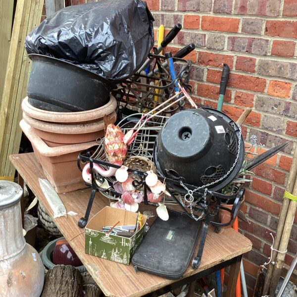Garden lot featuring a metal flamingo and terracotta plant pots.