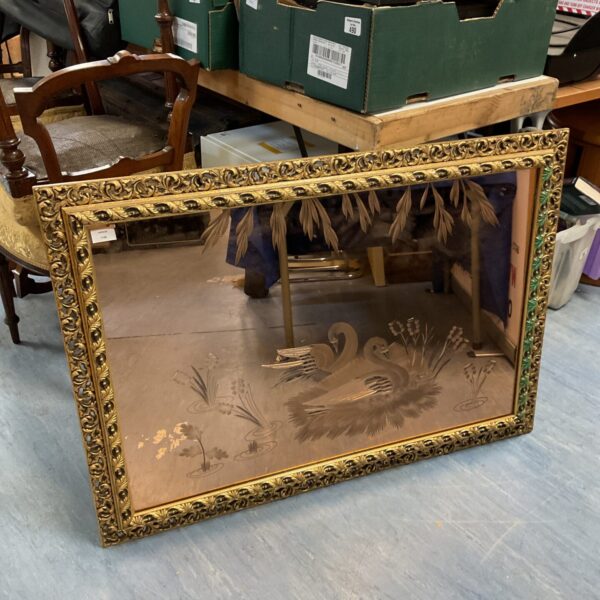 Large gilt framed swan mirror with pink glass panel.