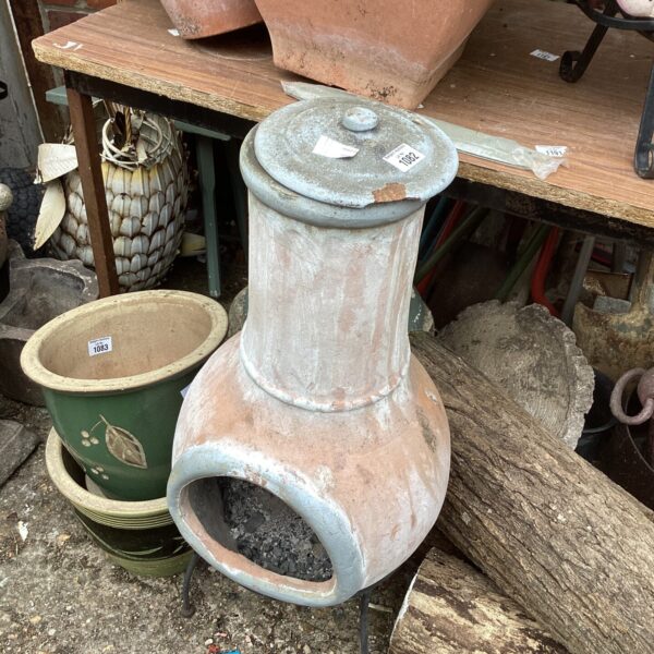 Vintage terracotta garden chiminea for outdoor heating and ambiance.