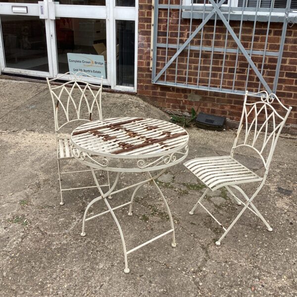 Vintage metal garden furniture set with table and two chairs.