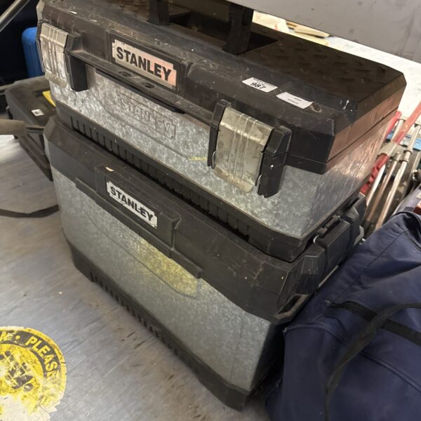 Stacked vintage Stanley toolboxes for tool storage.