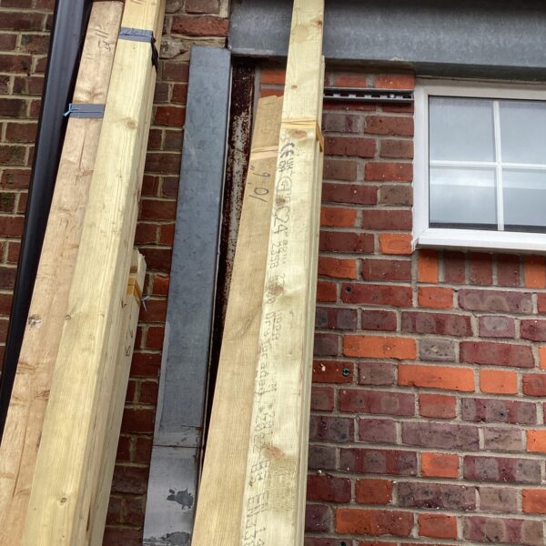 Three bundles of 10’6” timber stored outdoors, ready for construction.