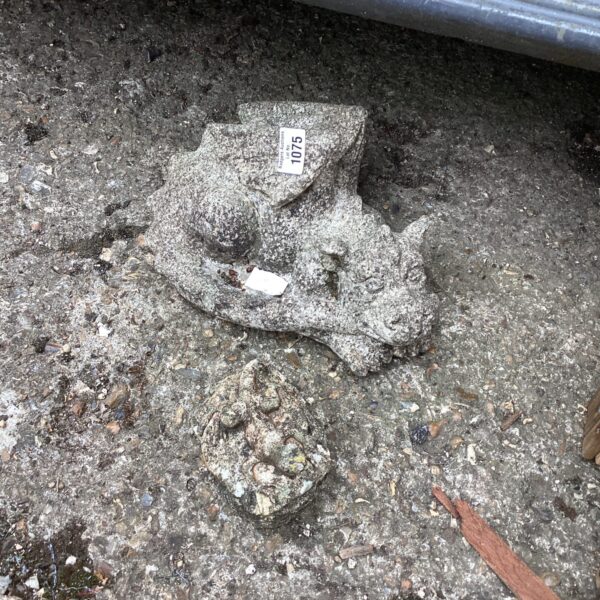 Weathered concrete garden dragon ornament for outdoor display.