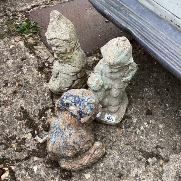 Vintage garden ornaments including a detailed cat statue.