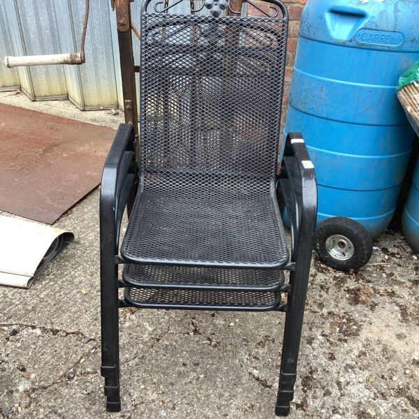 Vintage metal garden chair with mesh seat and wrought iron frame.
