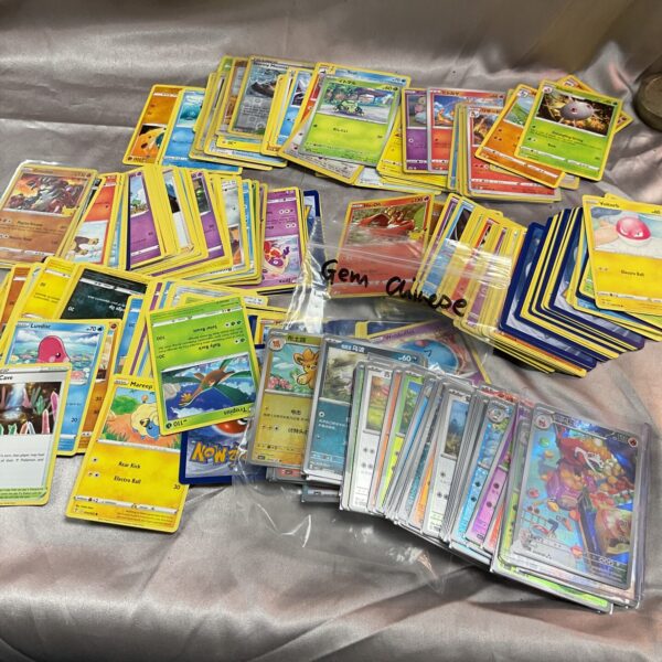 Assorted Pokemon card collection with Gem Chinese cards.
