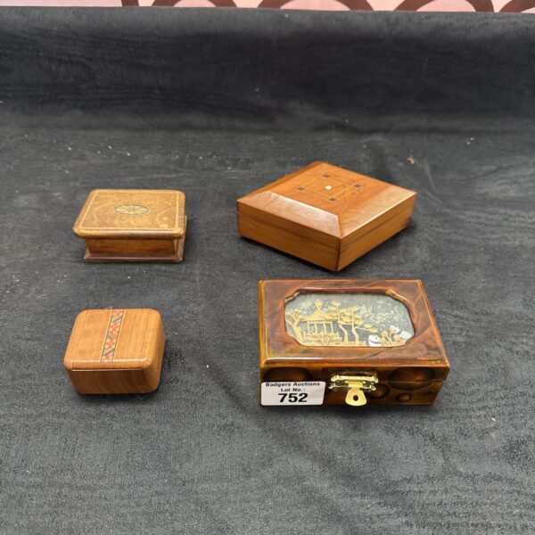 Group of three vintage wooden trinket boxes, decorative storage.