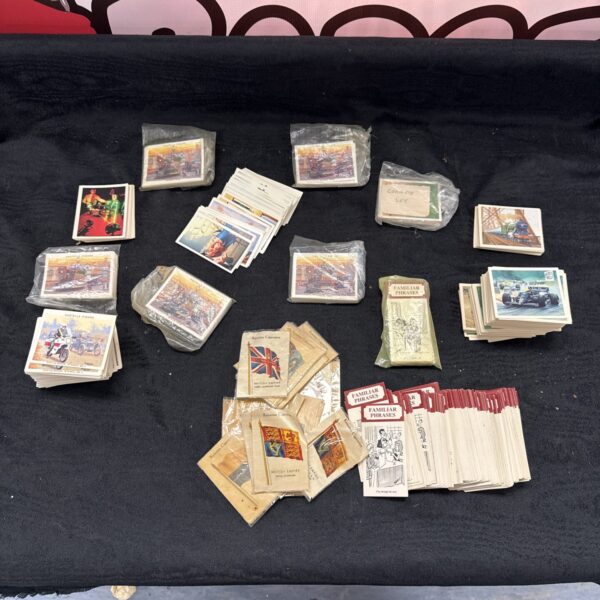 Vintage cigarette cards collection featuring diverse historical and military scenes.