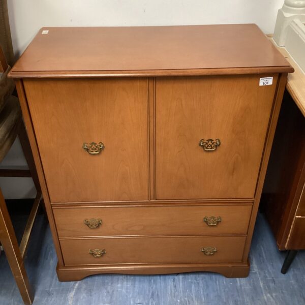 Vintage oak media cabinet with drawers and cupboard doors.