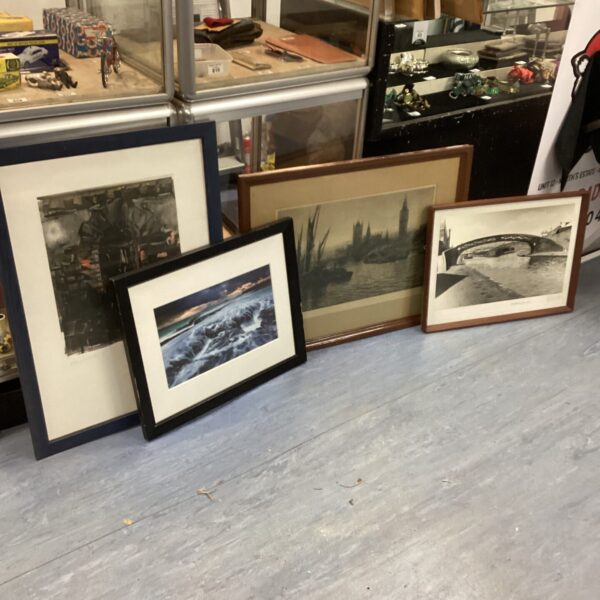 Collection of four vintage framed prints for wall decor.