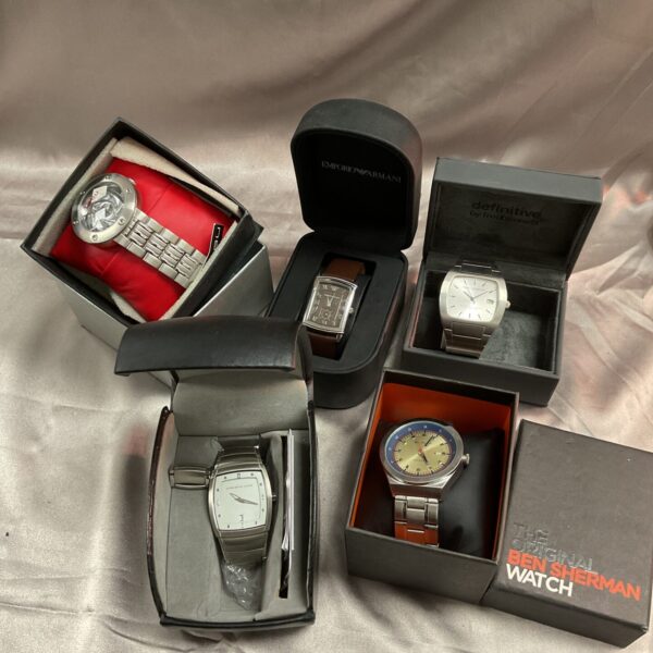 Five boxed wristwatches presented as a lot for sale.