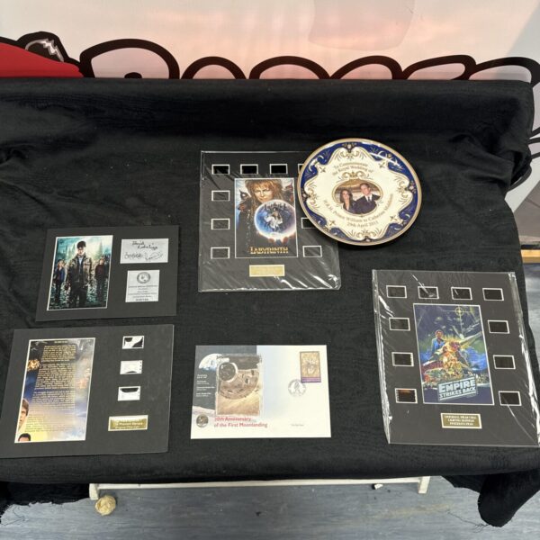 Movie memorabilia collection featuring signed posters and collectibles.
