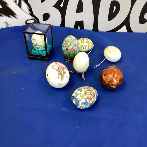Assortment of decorative painted eggs on a blue background.