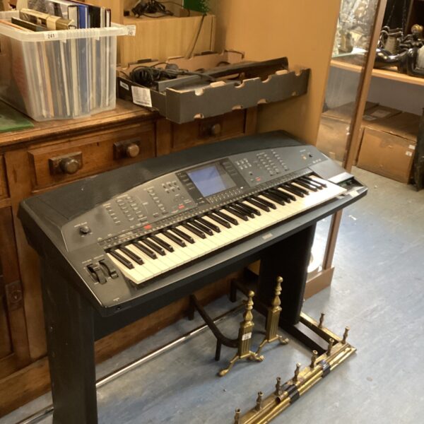 Vintage Yamaha PSR 4000 keyboard with stand, side view.