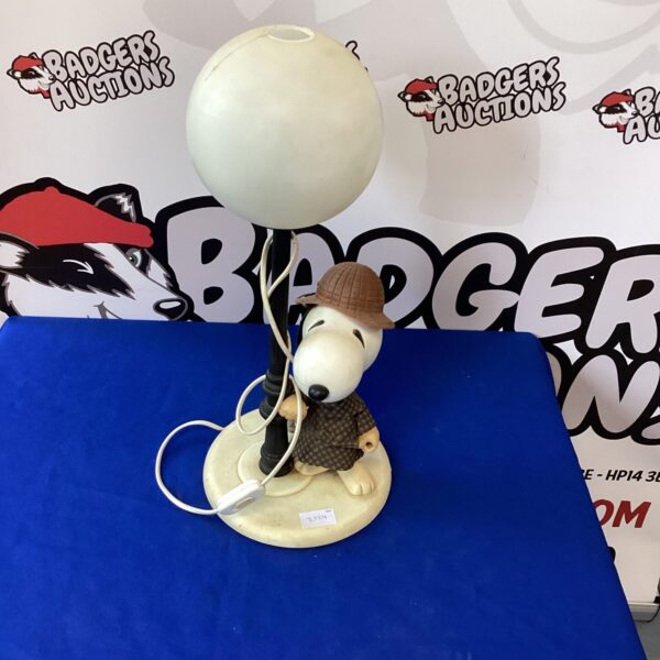 Vintage Snoopy lamp with warm-toned lampshade on display.