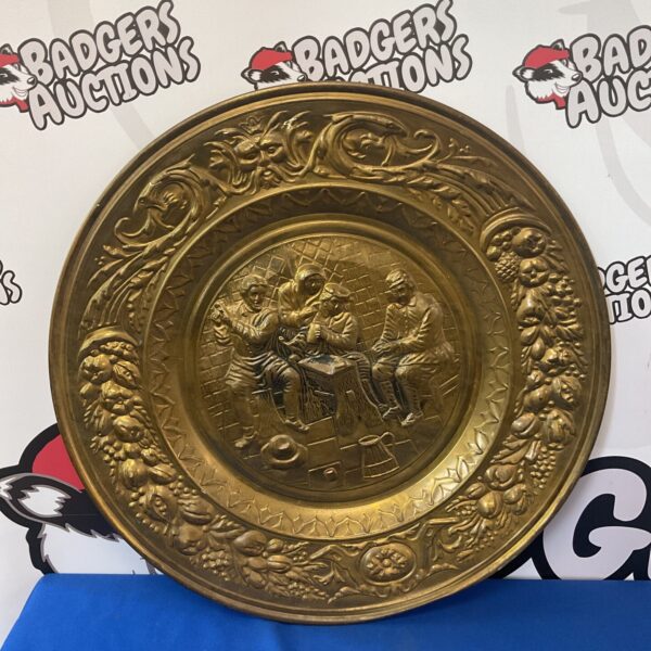 Large vintage brass tavern charger with detailed scene.