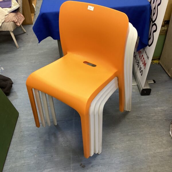 Vintage plastic reception chairs in white and orange.