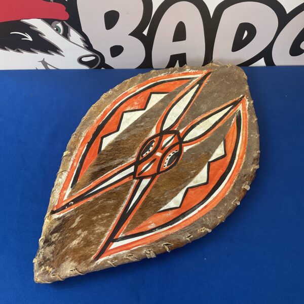 Authentic Maasai shield with geometric patterns on cattle hide.